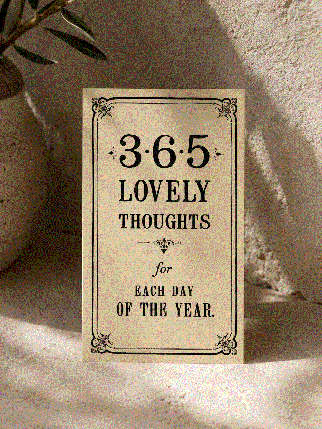 365 Daily Thoughts book with a beige cover, ornate black vintage lettering and decorative border reading “365 Lovely Thoughts.”