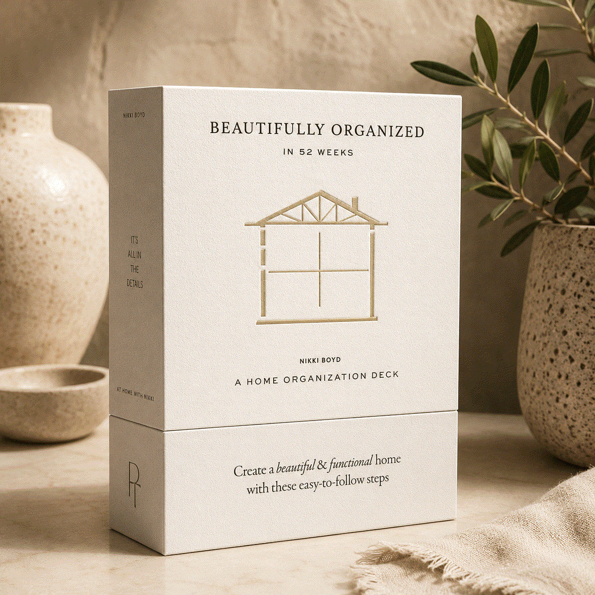 Beautifully Organized home organization card deck in a cream box with gold house illustration and black lettering