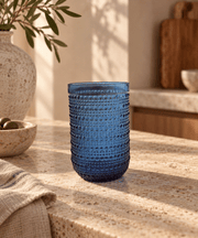 Blue Textured Highball Glass in deep blue glass with raised dotted bands and a tall, rounded silhouette