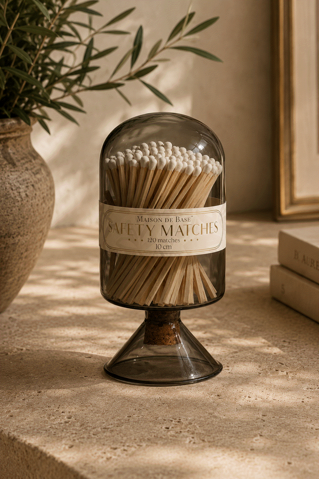 Glass Match Cloche in smoky brown glass, filled with long wooden matches and topped with a rounded dome lid