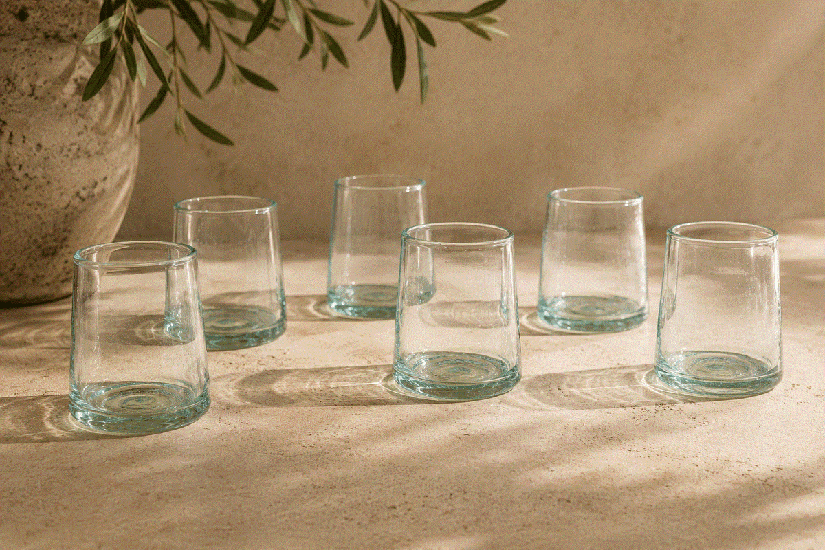 Handblown Moroccan Glass tumblers in clear recycled glass, with cone-shaped forms, aqua-tinted bases and subtle air bubbles
