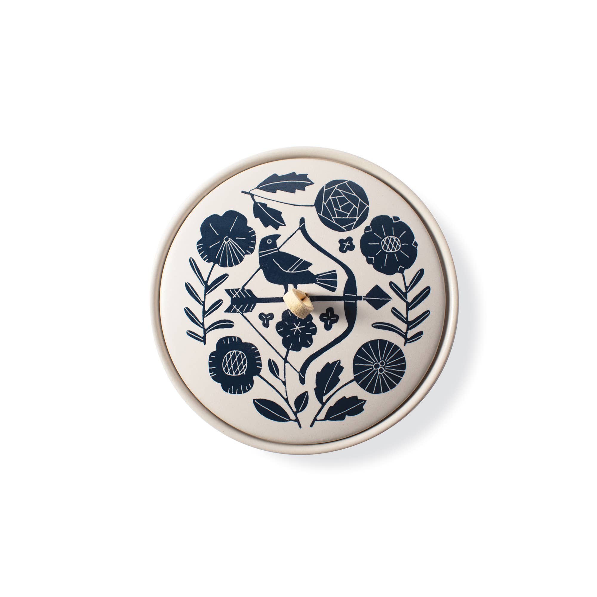 The Rooted Home round ceramic trinket box with a cream matte finish, navy floral pattern, and faux suede loop handle.