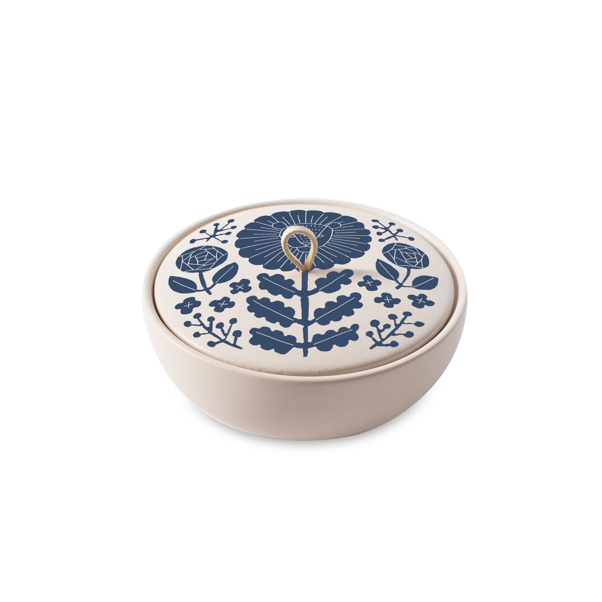 The Rooted Home ceramic trinket box with a matte cream finish, blue floral zodiac lid, and faux suede loop handle.