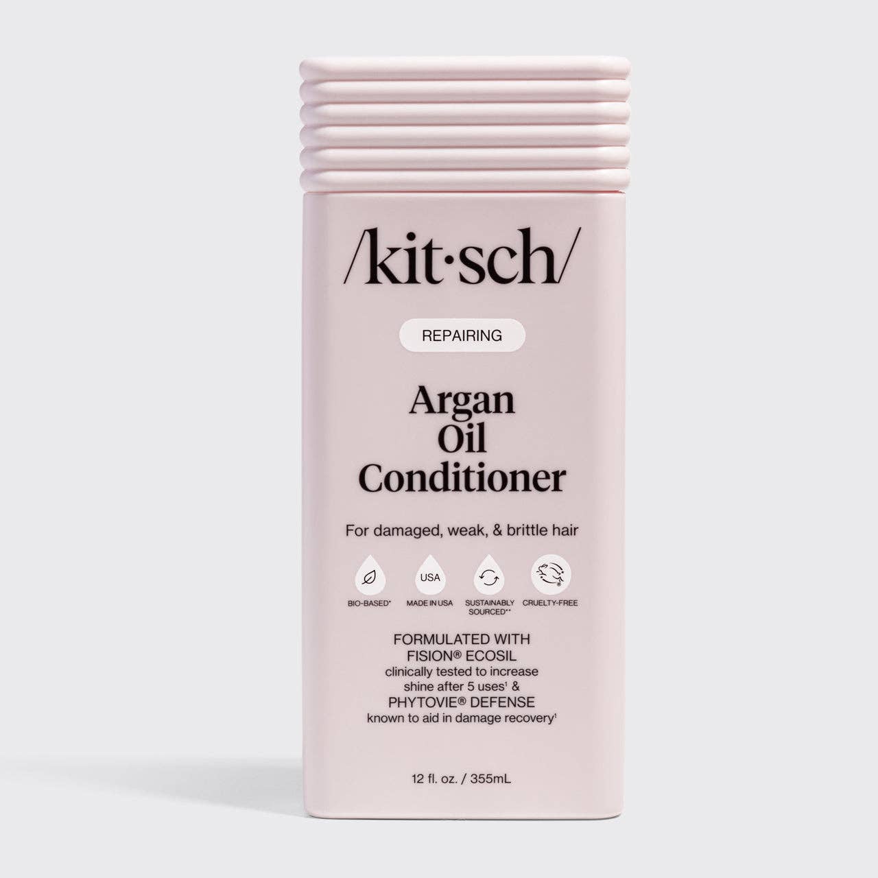The Rooted Home Kitsch Repairing Argan Oil Conditioner in a light pink bottle for damaged, weak, and brittle hair.