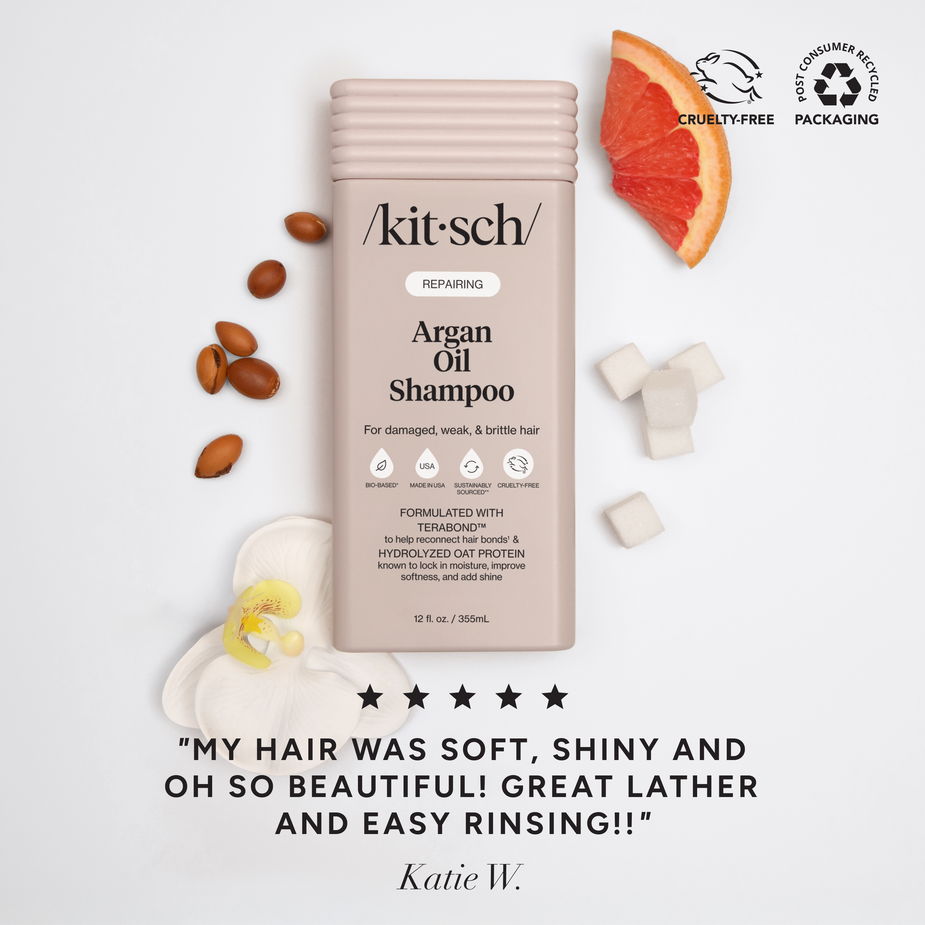 The Rooted Home Kitsch Repairing Argan Oil Shampoo bottle with grapefruit, argan nuts, and orchid flower accents.