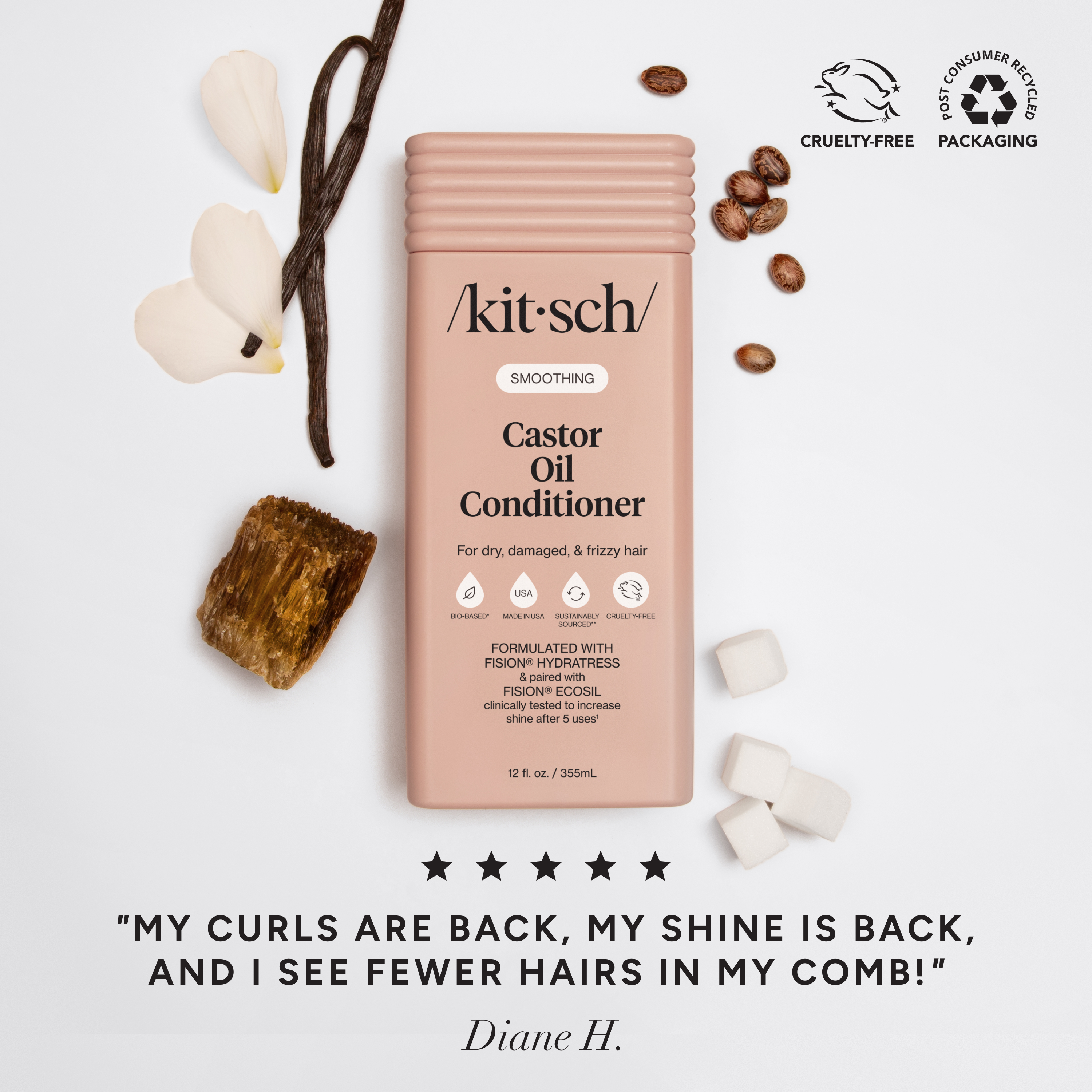 The Rooted Home Kitsch smoothing castor oil conditioner bottle in a soft pink shade with natural ingredients nearby.