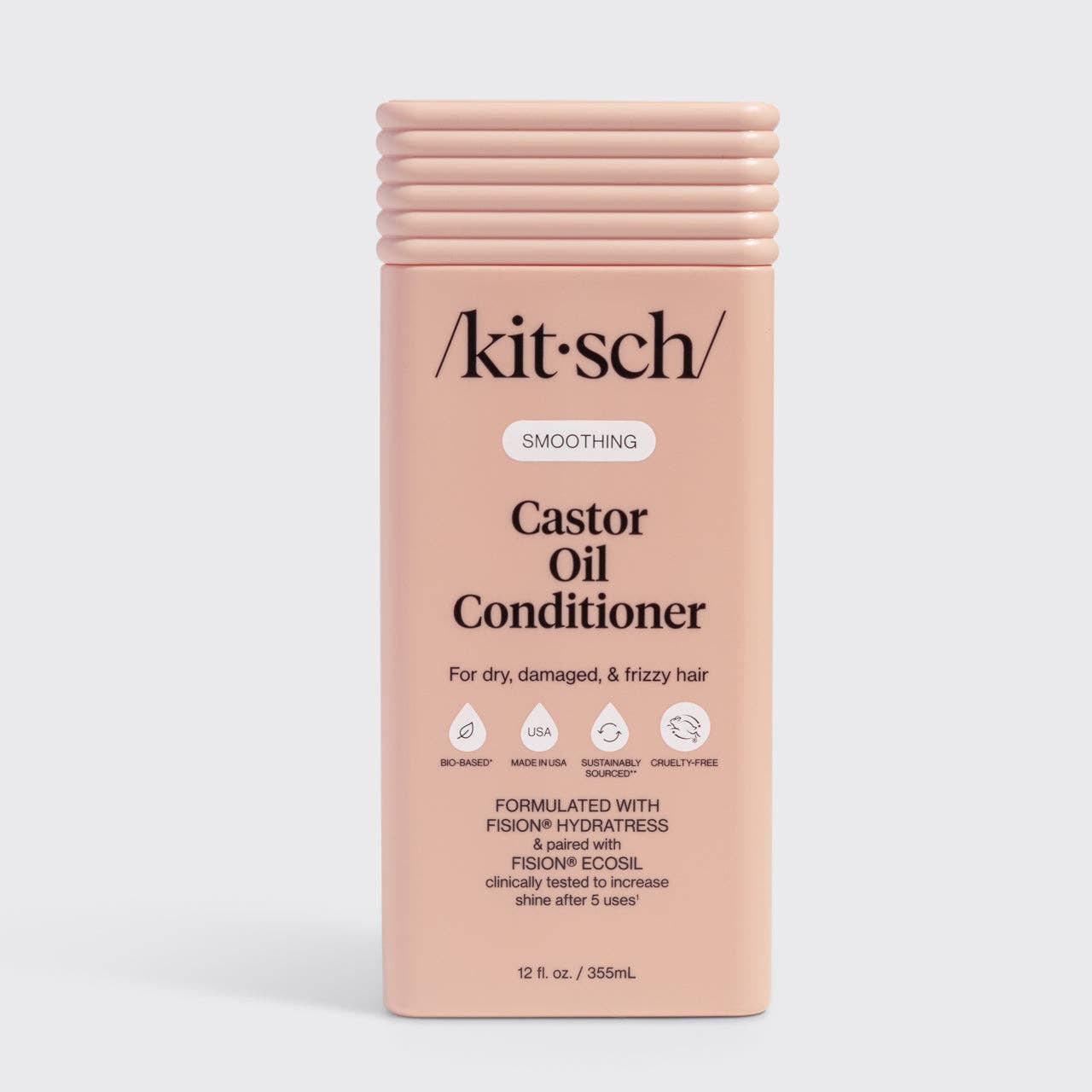 The Rooted Home Kitsch smoothing castor oil conditioner bottle for dry, damaged, and frizzy hair in a peach container.