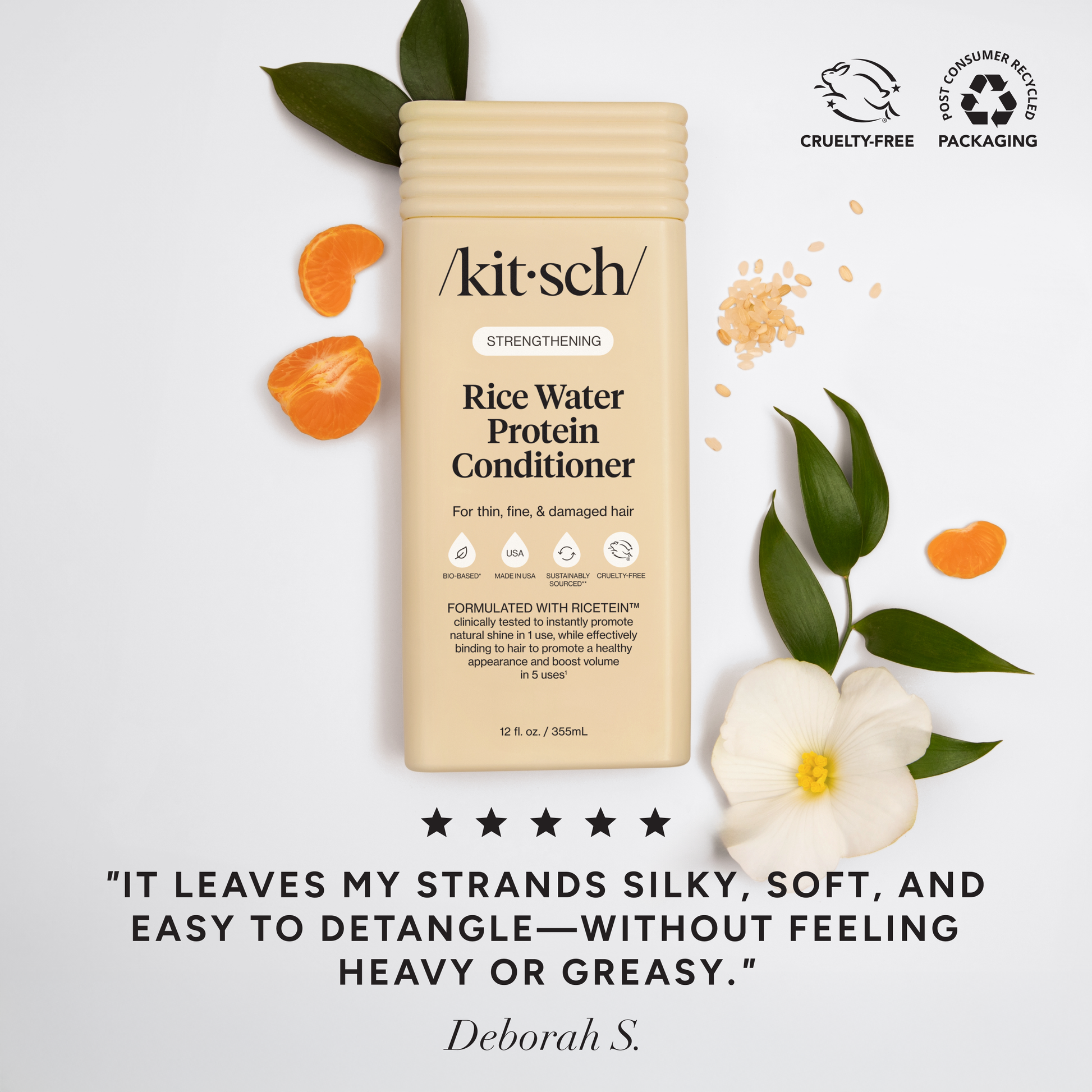 The Rooted Home Kitsch Strengthening Rice Water Protein Conditioner bottle with orange slices and white flower petals.
