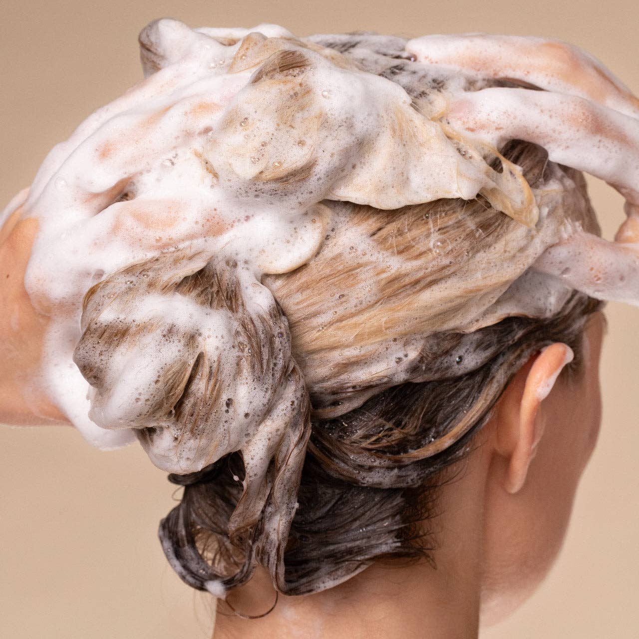 The Rooted Home Kitsch shampoo lathering in blonde hair for a clean, salon-quality hair care routine.
