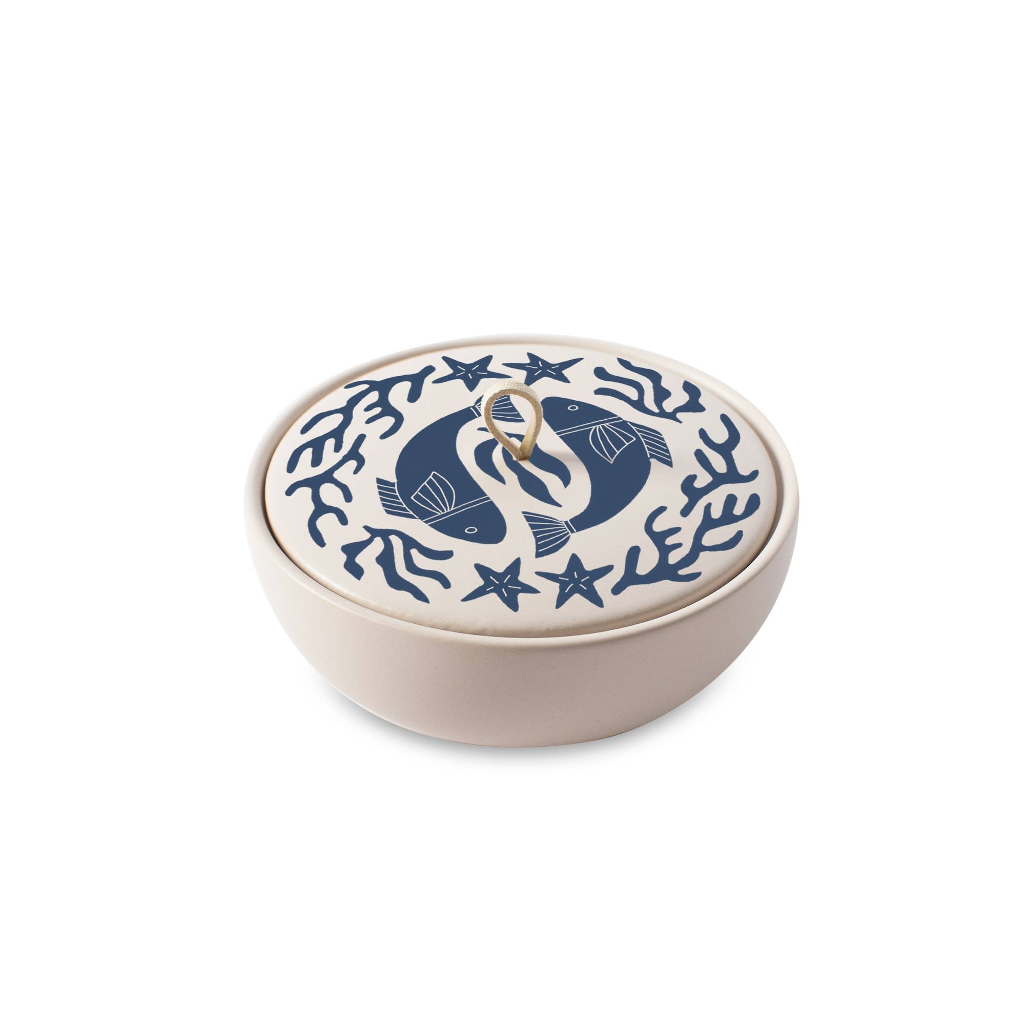 The Rooted Home Pisces zodiac ceramic trinket box with a matte finish, blue fish lid design, and faux suede loop.