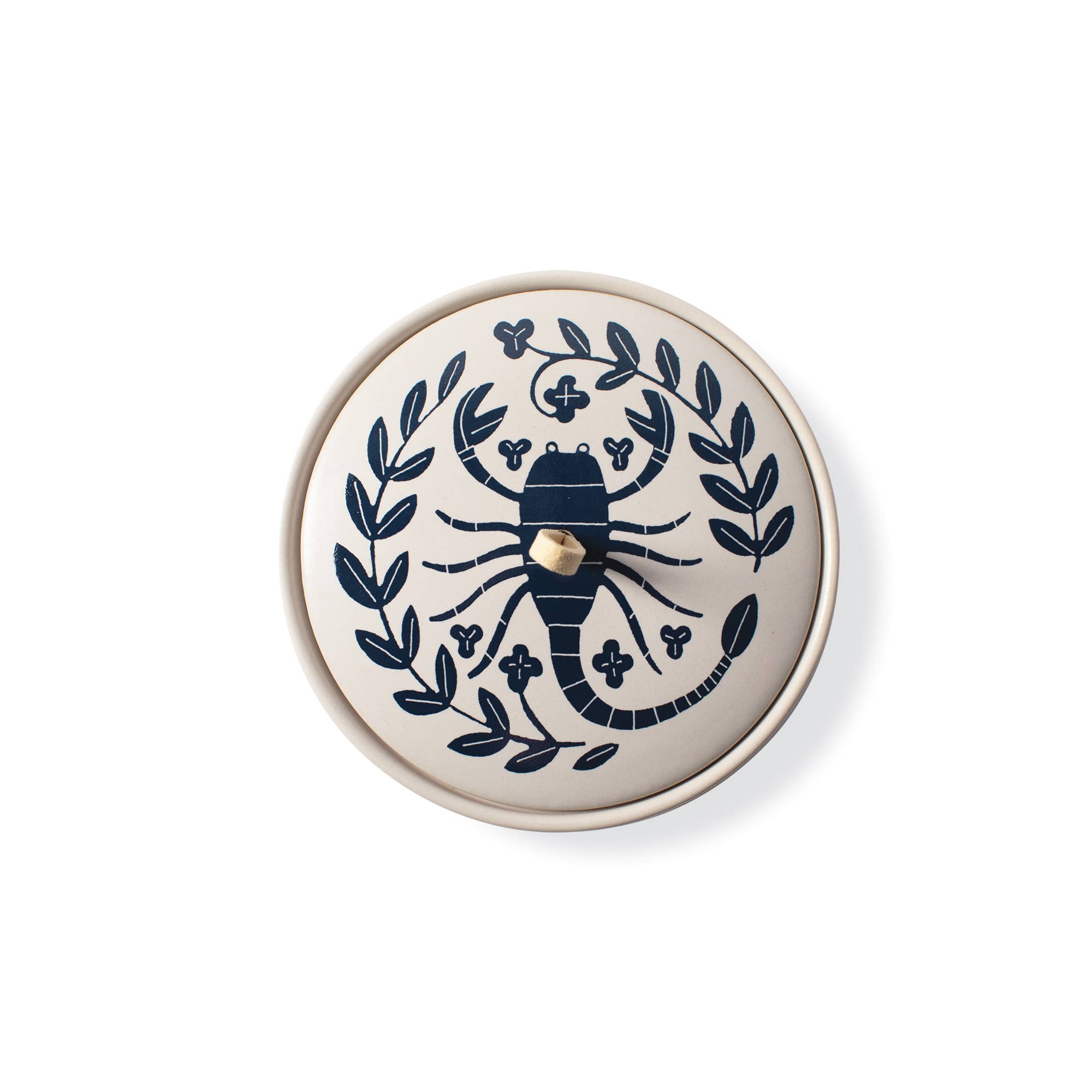 The Rooted Home Scorpio zodiac ceramic trinket box with a matte cream finish, navy scorpion design, and suede loop.
