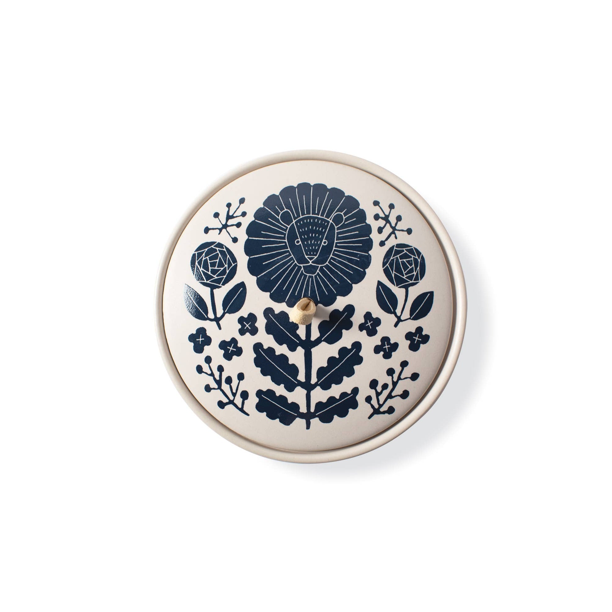 The Rooted Home round ceramic trinket box with a matte finish and a navy blue Leo zodiac floral illustration on lid.